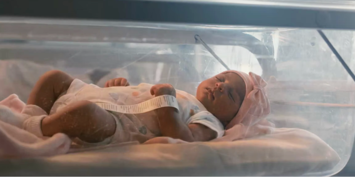 A baby lying in a cot.